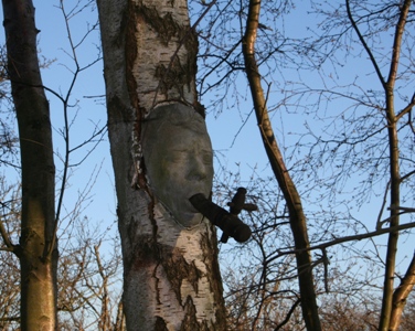 "Nature art" / skovtrold i cement. Forventes "spist" af træet i løbet af 10 år.